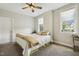 Cozy bedroom with natural light from two windows and a ceiling fan at 205 Sherman Pines Dr, Fuquay Varina, NC 27526