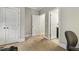 Bedroom featuring carpet and two doors. One leads to a closet and another to the bathroom at 205 Sherman Pines Dr, Fuquay Varina, NC 27526