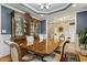 Elegant dining room featuring a large china cabinet with glass doors and stylish decor at 205 Sherman Pines Dr, Fuquay Varina, NC 27526