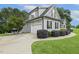Attached garage featuring upper floor with dormer windows and a seating area on the driveway at 205 Sherman Pines Dr, Fuquay Varina, NC 27526