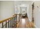 Upstairs hallway with hardwood floors and a cozy reading nook by the window at 205 Sherman Pines Dr, Fuquay Varina, NC 27526