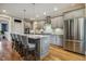 Kitchen island with barstool seating, stainless steel appliances, and wood flooring at 205 Sherman Pines Dr, Fuquay Varina, NC 27526