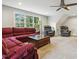 Bright living room with large windows, neutral tones, and ceiling fan at 205 Sherman Pines Dr, Fuquay Varina, NC 27526