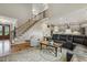 Welcoming living room with hardwood floors, staircase, and open layout to kitchen and dining at 205 Sherman Pines Dr, Fuquay Varina, NC 27526
