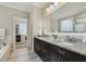 The main bathroom showcases double sinks with granite counters and an attached walk-in closet at 205 Sherman Pines Dr, Fuquay Varina, NC 27526
