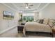 Bright main bedroom with large window, plant, ceiling fan, and comfortable bed at 205 Sherman Pines Dr, Fuquay Varina, NC 27526