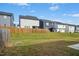 Fenced backyard with healthy lawn space, and adjacent neighboring homes at 21 Diploma Dr, Clayton, NC 27520