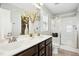 Elegant bathroom with double vanity, large mirror, stylish lighting and a glass shower at 21 Diploma Dr, Clayton, NC 27520