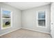 Bright bedroom with two windows offering ample natural light and neutral carpet at 21 Diploma Dr, Clayton, NC 27520