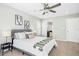 A stylish bedroom featuring a comfortable bed, modern art, and an adjacent bathroom at 21 Diploma Dr, Clayton, NC 27520