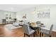 Cozy dining area open to the living room with a glass table and upholstered chairs at 21 Diploma Dr, Clayton, NC 27520