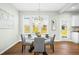 Dining area features a modern table with four chairs near white trimmed windows at 21 Diploma Dr, Clayton, NC 27520