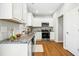 Modern kitchen features stainless steel appliances, granite countertops, and white cabinetry at 21 Diploma Dr, Clayton, NC 27520