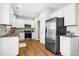 Modern kitchen features stainless steel appliances, granite countertops, and white cabinetry at 21 Diploma Dr, Clayton, NC 27520