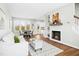 Cozy living room features a fireplace, built-in shelves, and open dining area at 21 Diploma Dr, Clayton, NC 27520