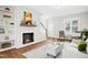 Bright living room with fireplace, white staircase, and an entry door to the house at 21 Diploma Dr, Clayton, NC 27520