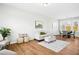 Bright living room with modern furniture, wood floors, and decorative accents at 21 Diploma Dr, Clayton, NC 27520