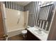 Bathroom featuring a tub and shower combination and dark wood cabinets at 2146 Charles St # 12, Durham, NC 27707