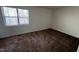 A cozy bedroom with carpeted floors and a bright window at 2146 Charles St # 12, Durham, NC 27707