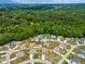 Scenic aerial view showcasing a neighborhood surrounded by lush greenery at 222 Trailing Oak Trl, Clayton, NC 27527