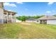 Large, grassy backyard with a covered porch and room for outdoor activities at 222 Trailing Oak Trl, Clayton, NC 27527