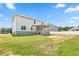 Backyard features a two-story home, green grass, and screened in porch at 222 Trailing Oak Trl, Clayton, NC 27527
