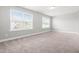 Bedroom filled with natural light from two large windows and a view of the neighborhood at 222 Trailing Oak Trl, Clayton, NC 27527