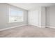 Bright bedroom featuring a large window and ample closet space at 222 Trailing Oak Trl, Clayton, NC 27527