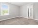 Well-lit bedroom with open doorway offering easy access to other rooms at 222 Trailing Oak Trl, Clayton, NC 27527