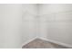 An empty walk-in closet features wire shelving and neutral carpeting at 222 Trailing Oak Trl, Clayton, NC 27527