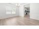 Empty dining room featuring a modern chandelier, white wainscoting, and wood floors at 222 Trailing Oak Trl, Clayton, NC 27527