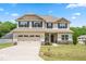 Charming two-story home featuring a two-car garage, well-manicured lawn, and classic curb appeal at 222 Trailing Oak Trl, Clayton, NC 27527