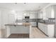 Well-lit kitchen with white cabinets, granite countertops, stainless appliances, and a center island at 222 Trailing Oak Trl, Clayton, NC 27527