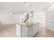 Spacious kitchen featuring a large center island, stainless steel appliances and white cabinetry at 222 Trailing Oak Trl, Clayton, NC 27527
