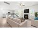 Bright living room with modern fireplace open to kitchen with white cabinets and stainless steel appliances at 222 Trailing Oak Trl, Clayton, NC 27527
