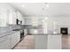 Open-concept floor plan with hardwood floors seamlessly connects the living area, staircase, and kitchen at 222 Trailing Oak Trl, Clayton, NC 27527