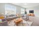 Cozy living room with comfortable seating, lots of light, and a shaggy area rug at 222 Trailing Oak Trl, Clayton, NC 27527