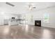 Bright living room with modern fireplace open to kitchen with white cabinets and stainless steel appliances at 222 Trailing Oak Trl, Clayton, NC 27527