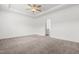 Large main bedroom featuring a tray ceiling, a ceiling fan, and plush carpeting at 222 Trailing Oak Trl, Clayton, NC 27527