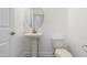 Elegant powder room featuring a pedestal sink, a round mirror, and a toilet at 222 Trailing Oak Trl, Clayton, NC 27527