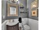 Charming powder room with decorative mirror, elegant fixtures, and modern finishes at 231 Grindstone Dr, Apex, NC 27502