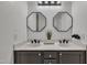 Bathroom with double sinks, gray cabinets, modern light fixture, and black hardware, perfect for contemporary living at 231 Grindstone Dr, Apex, NC 27502