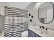 Charming bathroom featuring a sink, cabinet and unique striped shower curtain, adding a modern touch at 231 Grindstone Dr, Apex, NC 27502
