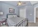 Comfortable bedroom with a ceiling fan, side table, and closet, creating a cozy and functional space at 231 Grindstone Dr, Apex, NC 27502