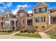 Brick townhome with black shutters and a well-manicured lawn at 231 Grindstone Dr, Apex, NC 27502