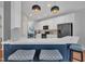 Modern kitchen with white cabinets, stainless steel appliances, breakfast bar and stylish pendants at 231 Grindstone Dr, Apex, NC 27502
