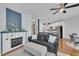 Inviting living room with fireplace, plush seating, and stylish decor, with a glimpse of the kitchen at 231 Grindstone Dr, Apex, NC 27502