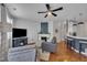 Open-concept living room with fireplace, comfortable seating, and seamless flow to the kitchen at 231 Grindstone Dr, Apex, NC 27502