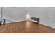 Minimalist living room with a light, black storage cabinet, and dark wood floors at 231 Grindstone Dr, Apex, NC 27502