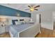 Comfortable main bedroom featuring a plush bed, stylish decor, and plenty of natural light at 231 Grindstone Dr, Apex, NC 27502